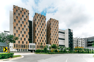  On 20.000 m2 building land Straits Construction has constructed a twelve-storey dormitory block (in front) and a precast concrete element factory on a total of four levels with attached high-bay warehouse  