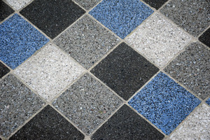  The marbling of the tiles is caused by polished concrete. Black stones are added to the blue-colored concrete and come to the surface after polishing 