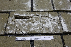  Close-up view of the detached facing on concrete paving block “10/11/3“ 