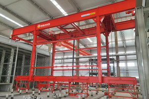  The storage and retrieval system will store the pallets containing the freshly poured slabs in a curing rack and retrieve them after an appropriate curing time 