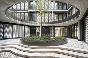  In the inner courtyard, smooth gray concrete on joists and balcony slabs complements the jagged pattern of the façade surfaces 