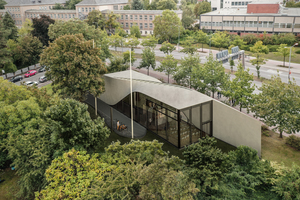  Fig.: Cube carbon-reinforced concrete building, view of the steel-glass façade and Twist roof-wall structure 