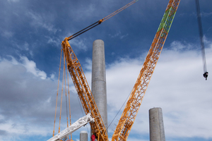  Some of the partially assembled towers and the giant mobile crane which lifted the segments into position  