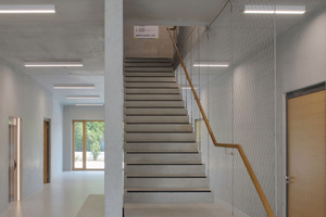  In the entrance hall, visitors are greeted by a sculpture-like stair that leads to the office floors 