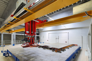  For finishing the surface, after an initial, short hardening phase, the storage retrieval machine moves the wall to the finishing area, which is located directly above the second rack tower 