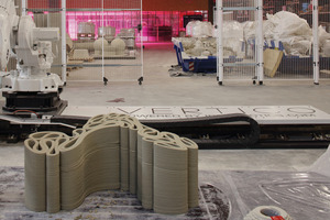  Elements of this park bench engage with each other. A corresponding stool element also fits into the bulge in the foreground, creating the seating portion of this piece of street furniture. 