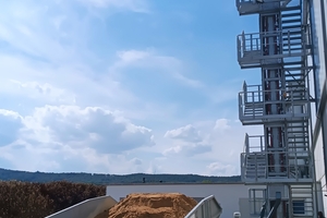  Links im Bild der VHV FlatFeeder mit den teilbefahrbaren Spaltenrosten. Dieser wurde im März 2022 bei Weser-Diemel-Beton montiert und in Betrieb genommen. Dahinter der Treppenaufgang am Doppelgurtförderer aus den für VHV typischen Modulsystemen 