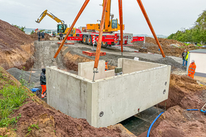  The first of a total of six structures is placed in the excavation  
