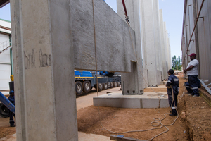  A precast concrete panel is installed between columns in the narrow strip section  