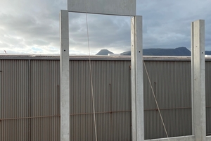  Precast concrete panels are lowered into position in the open area 