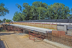  Abutment extension reinforcing (foreground) and one of arched walkways under construction 