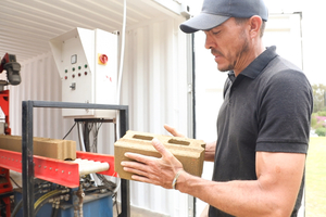  Freshly-cast Click Brick building blocks are conveyor-fed for easy retrieval 