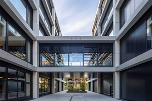  On the first floor, two continuous bridges establish a structural link between the three buildings  