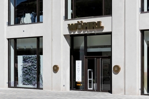  The two-story portals generously open the building onto the pedestrian zone, creating transparency for retail spaces  