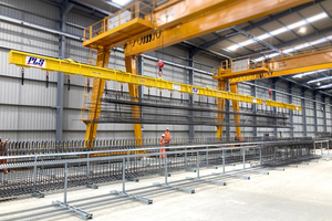  Fig. 2: Positioning with pinpoint precision: An overhead gantry crane moves preassembled reinforcement cages out of the JIG System  