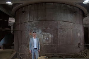  Jiming Cai, founder and owner of C&amp;G Pigment, in front of a spray tower 
