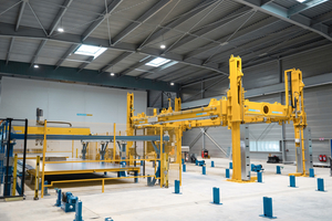  Fig. 4: The new turning unit picks two pallets at the same time and turns them about 180 degrees. This allows a load-bearing structure made of standard concrete to be applied to the top of the wood concrete element  