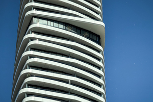  Surrounding, round curved balconies and a constricted central part characterize the façade of the building that is elegantly rising upwards 