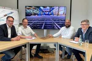  Fig. 8: Close collaboration was instrumental to project success: Jörg Springsguth from Mitsubishi Electric conversing with Stefan Broeckmann, Stephan Terhoeven, and Marc Orgassa (from left)  