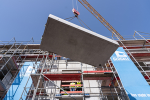  Fig. 1: The balcony slab is lifted into place by crane  