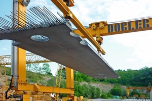  Fig. 1 Transport by crane of extra-long precast concrete slabs with strengthened Filigran EV lattice girders. 