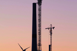  → 2 The hybrid towers are erected by self-climbing tower cranes.  