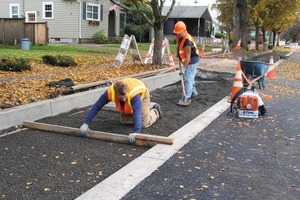  Fig. 7 A makeshift screed levels the bedding course for the permeable pavers.  