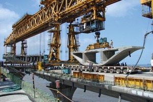  Fig. 3 Delivery of a segment on a multiple axis trailor to the erection gantry over already erected part of  the viaduct. 