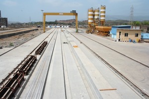  The MAADcrete production line for Spancrete hollowcore elements in the Indian town of Vasai East has a length of 200 m; in the background right there is the batching plant with bins 