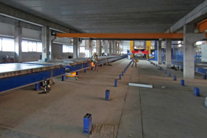  7The pallets are transported directly underneath the trowel station through to the curing chamber 