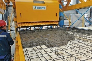  Pouring the concrete of the first solid wall element by means of the concrete spreader of Ebawe 