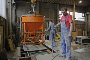  The workers place a perforated form panel over the reinforcement prior to casting. This simple trick effectively prevents formation of unsightly concrete circles  