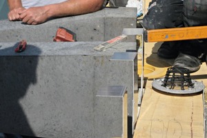  Roofers line the precast element with sheet metal and connect it to the roof drainage system 