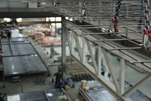  In one of two production buildings, steel reinforcement is straightened, cut and welded by Progress plants installed on a platform prior to being placed, through an opening, on a pallet of the circulation system on the ground floor  