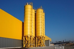  Abb. 1 Aufbau der Bindemittelsilos seitlich neben des in der Halle aufgebauten Mischturms. 