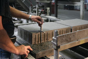  Production manager Jürgen Fraune has stopped the production line and performs a random check to measure the block height  