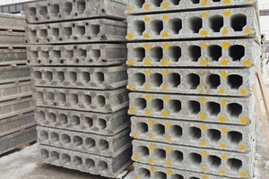  Finished prestressed concrete hollow-core floor slabs are stored outdoors, awaiting their loading and transport to the ­construction site 