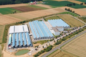  Fig. 1 The extended production facility from Paul (front) with the biomass power plant (back). 