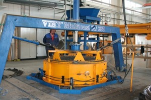  Fig. 1 Filled automatically the machine is compacting the precast concrete elements. 