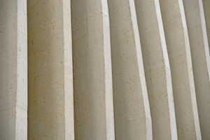  The surface of the concrete pilaster strips emulates the natural surface of travertine  