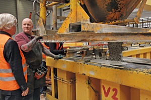  The self-compacting concrete (SCC) is poured into the mold from above using a spreading hopper 