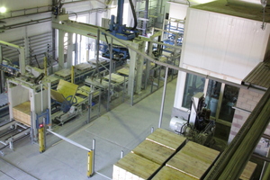  View of the packaging area from the mixer tower with the buffer for support boards, the enclosure for system control and the block-making machine in the background  