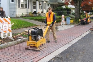  Fig. 9 Installed pavers were compacted, the openings filled with the bedding stone and compacted to about 3/8 in. (10 mm) above the new concrete curbs.  