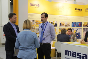  Talking to clients at the Masa booth
 