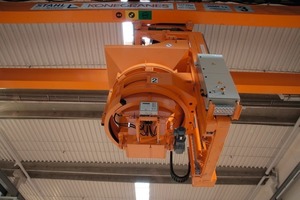  Fig. 5 The concrete distributor suspended from the crane suspended with the control cabinet fitted to its side.  